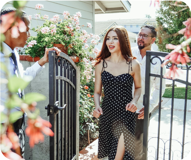 Woman in a dress walking through a gate