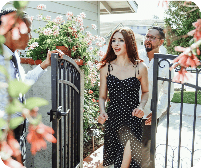 Woman in a dress walking through a gate