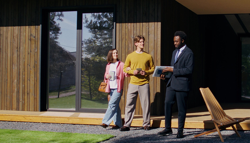 A real estate agent gives a couple a tour around a house.
