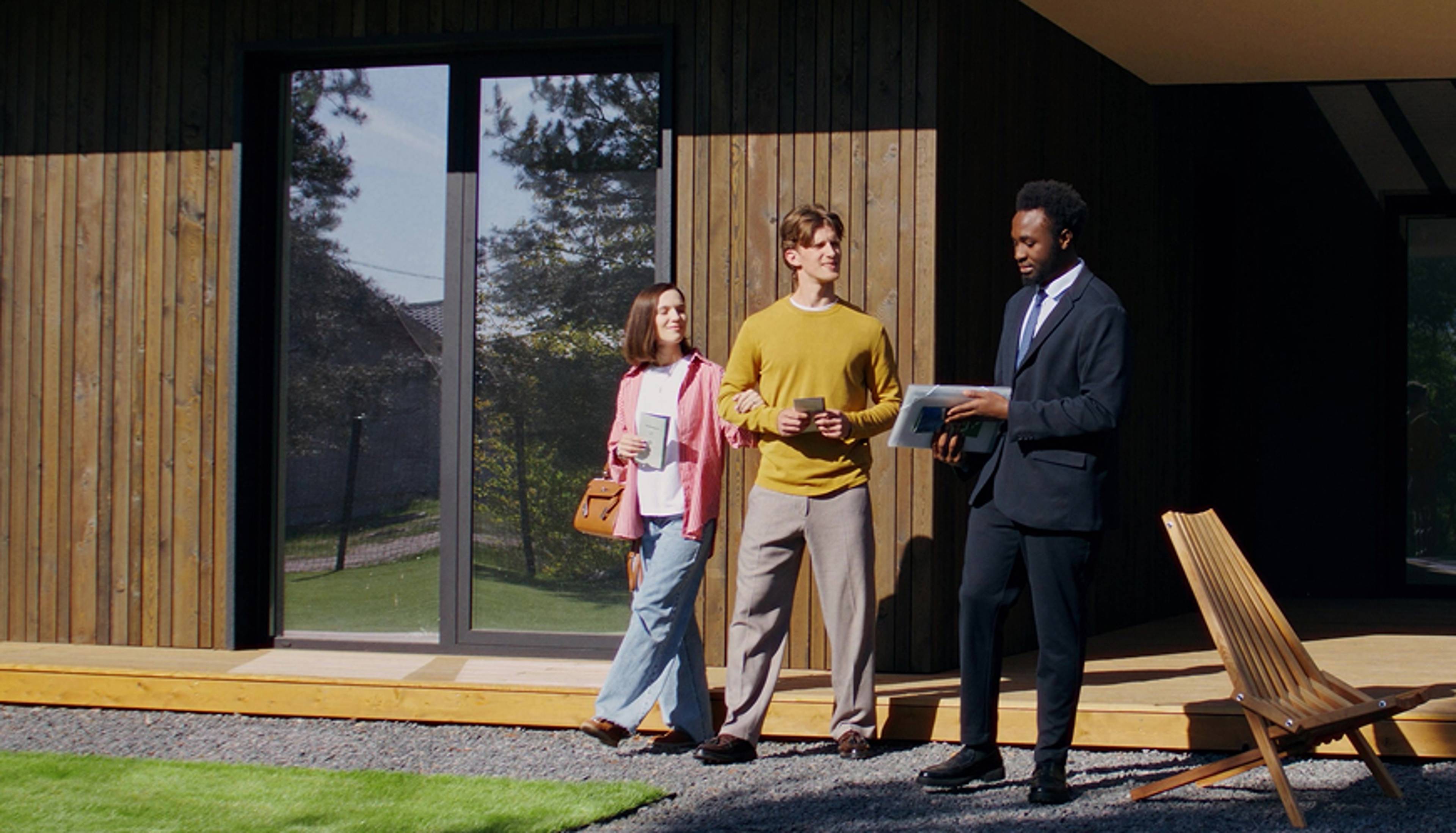A real estate agent gives a couple a tour around a house.