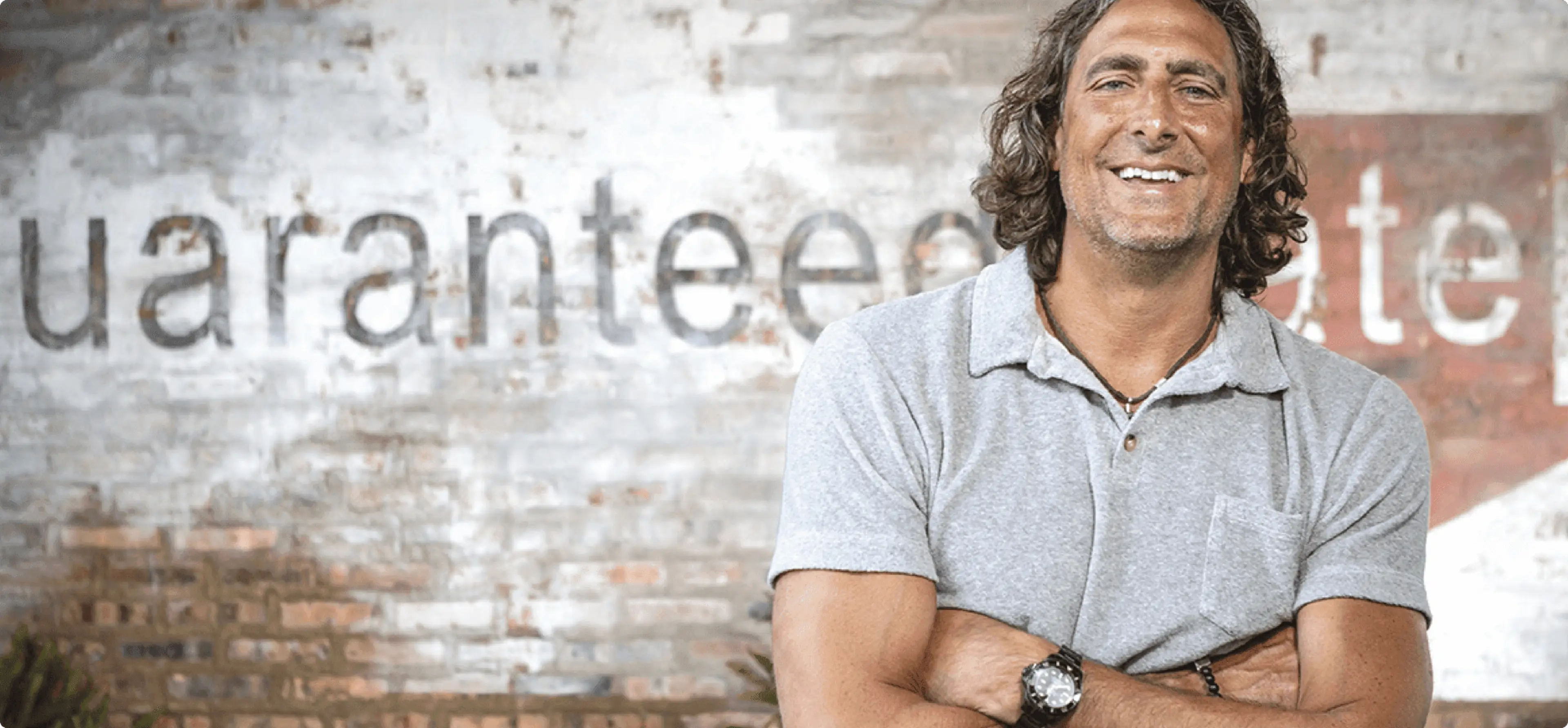 Victor Ciardelli standing in front of a brick wall.