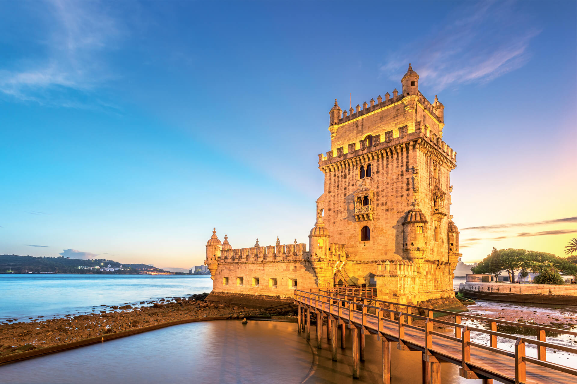 Sunset over Belém Tower overlooking the Tagus River in Lisbon, Portugal.