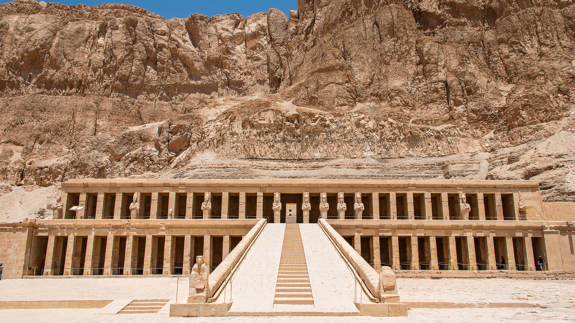 Hatshepsut Temple in Luxor, Egypt, with its monumental terraces set against the rocky desert cliffs.