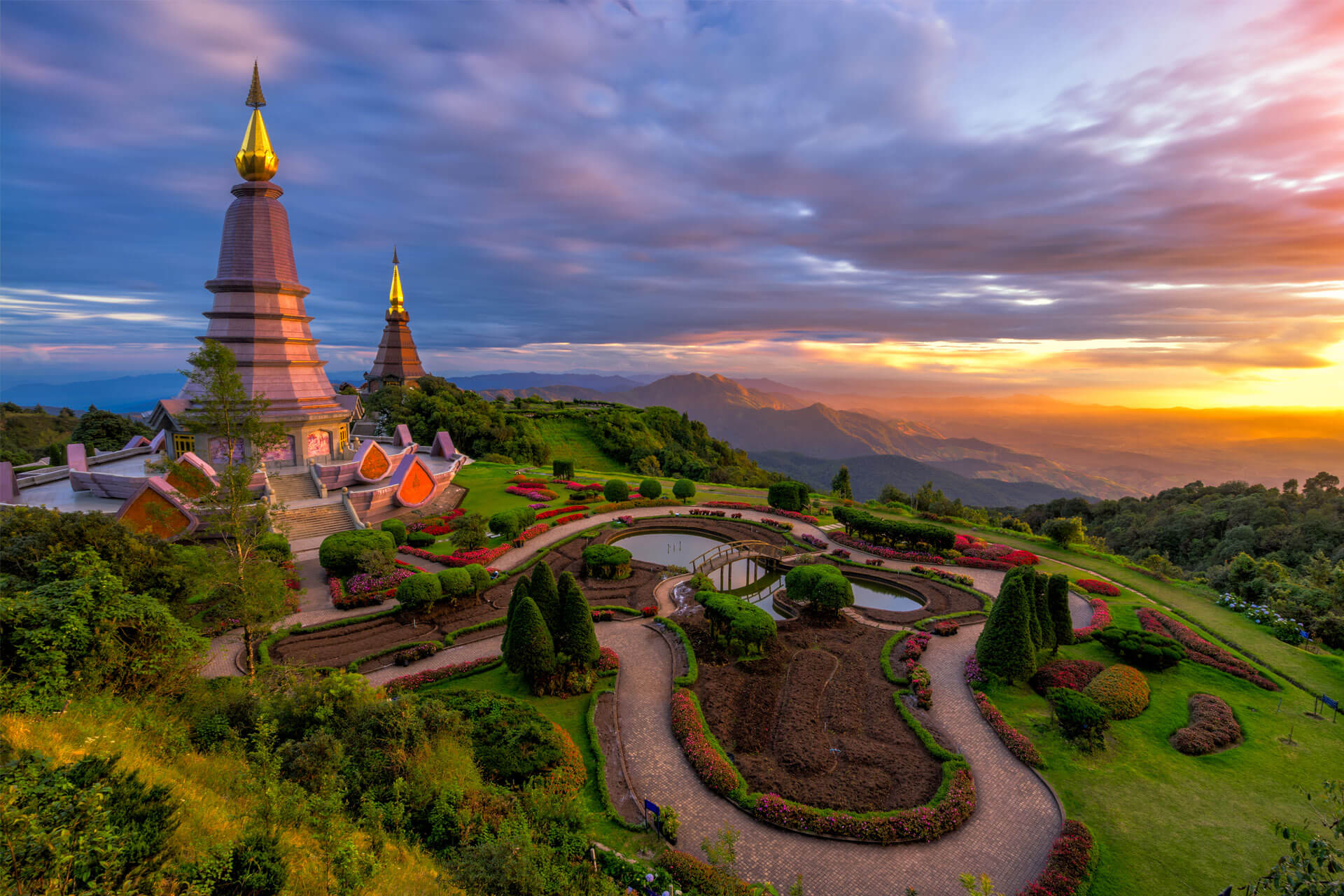 Buddhist pagodas at Doi Inthanon in Chiang Mai, Thailand, perched on a mountain and surrounded by colourful gardens.