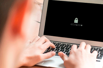 Someone working on a laptop and the screen shows a padlock