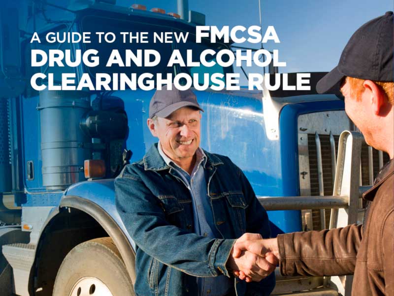 Two men shaking hands next to semi truck