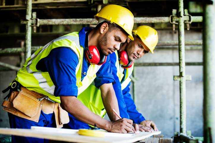 Construction workers at a drafting table