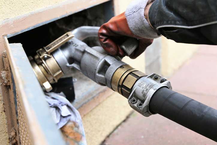 Worker operating a fuel hose.