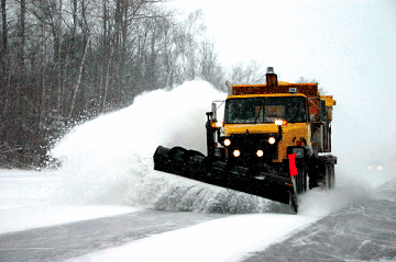 Snow plow removing snow from road.