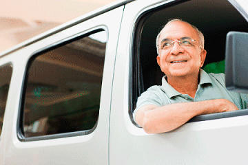 Passenger smiling out vehicle window