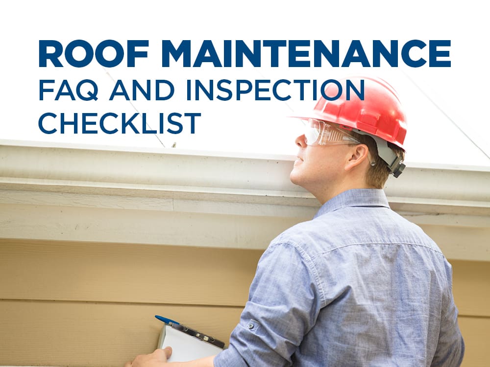 Man in hardhat and goggles on a ladder inspecting a roof