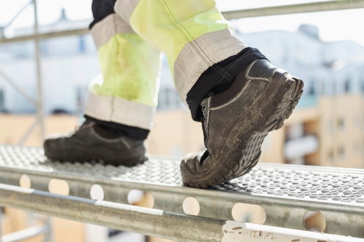 A person walking on scaffolding.