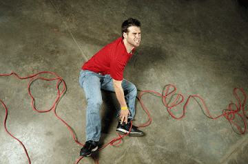 man with a hurt ankle after tripping on a chord