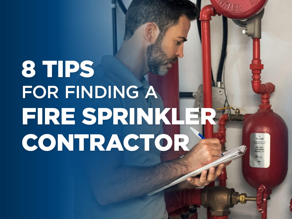 Man with a clipboard and pen assessing a fire sprinkler system