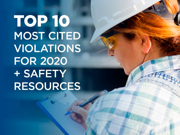 Woman in hardhat filling out a form on a clipboard