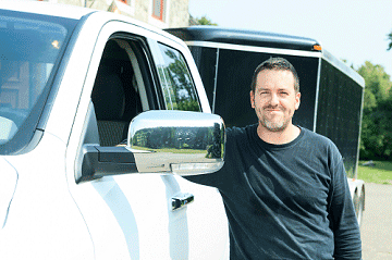 Someone standing next to a pickup truck