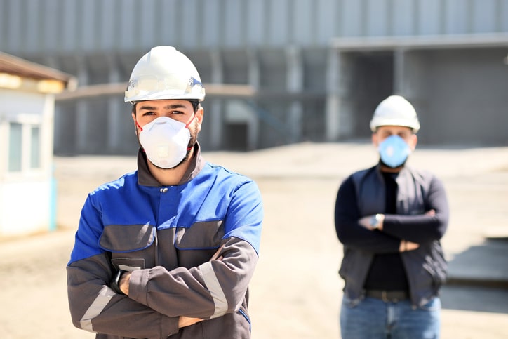 Two masked construction workers