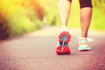 Runner in sneakers on a paved trail