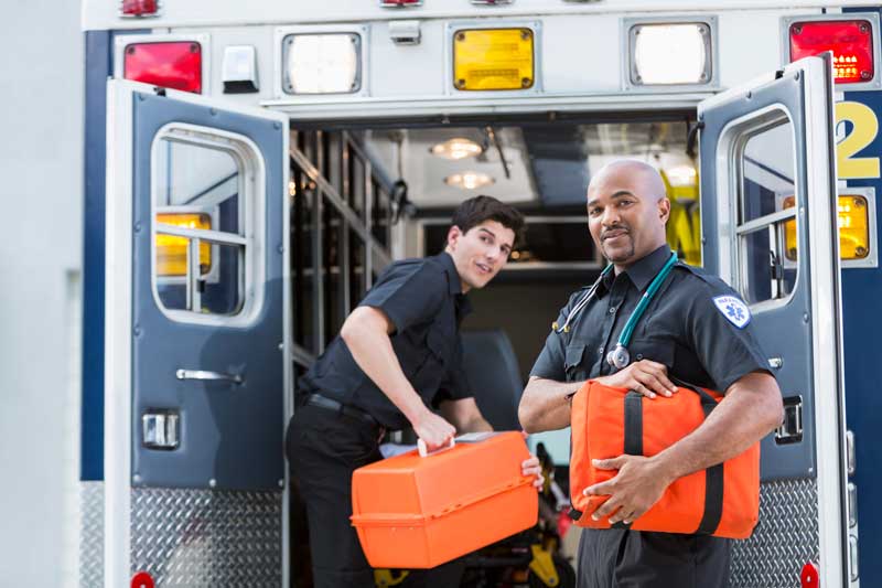 Paramedics loading up an ambulance with supplies