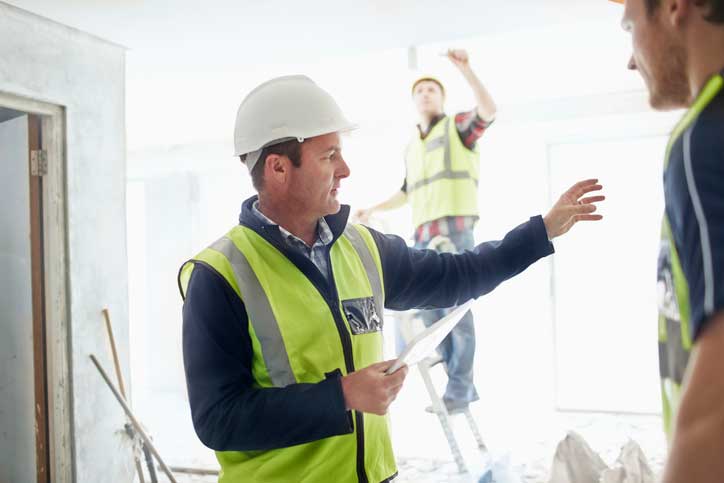 Foreman negotiating what should be done at a construction site