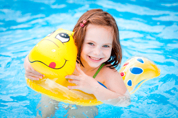 Kid at a swimming pool on a floaty