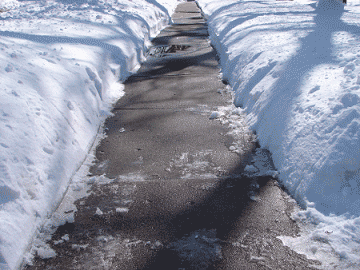 Snowy sidewalk that has been shovelled