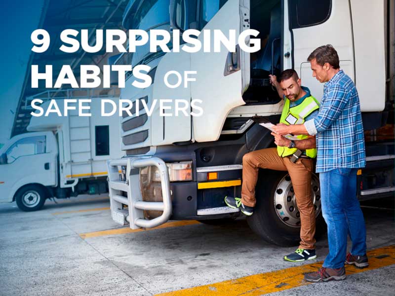 Two men reviewing papers next to a semi truck