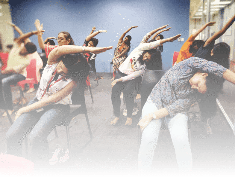 Group of women participating in a chair yoga class, Mumbai.