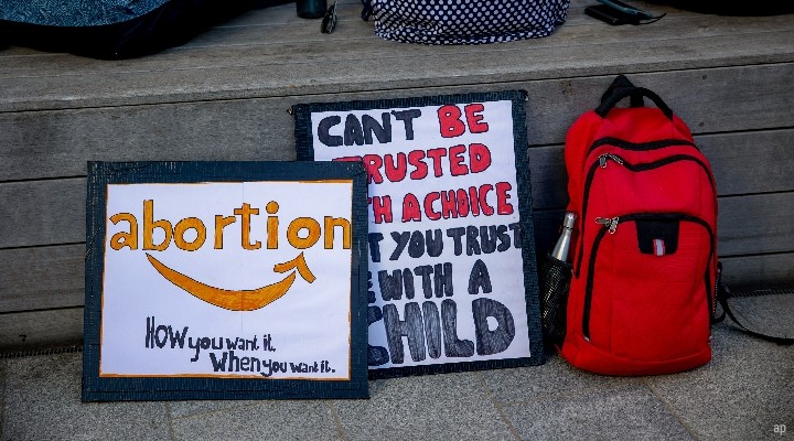 Abortion protest sign in style of Amazon logo