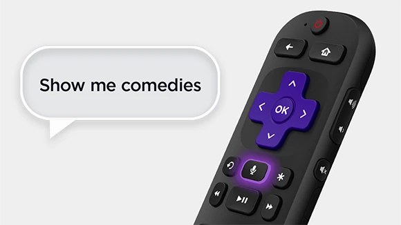 Man speaking into the Roku voice remote.