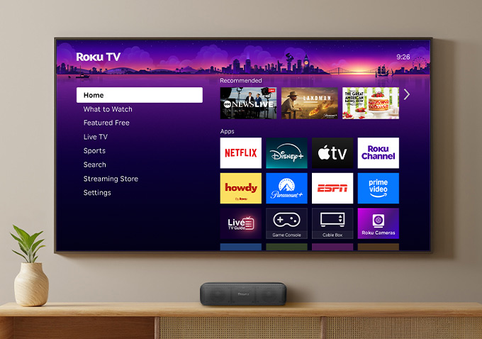 Roku TV showing Roku Homepage mounted on a wall