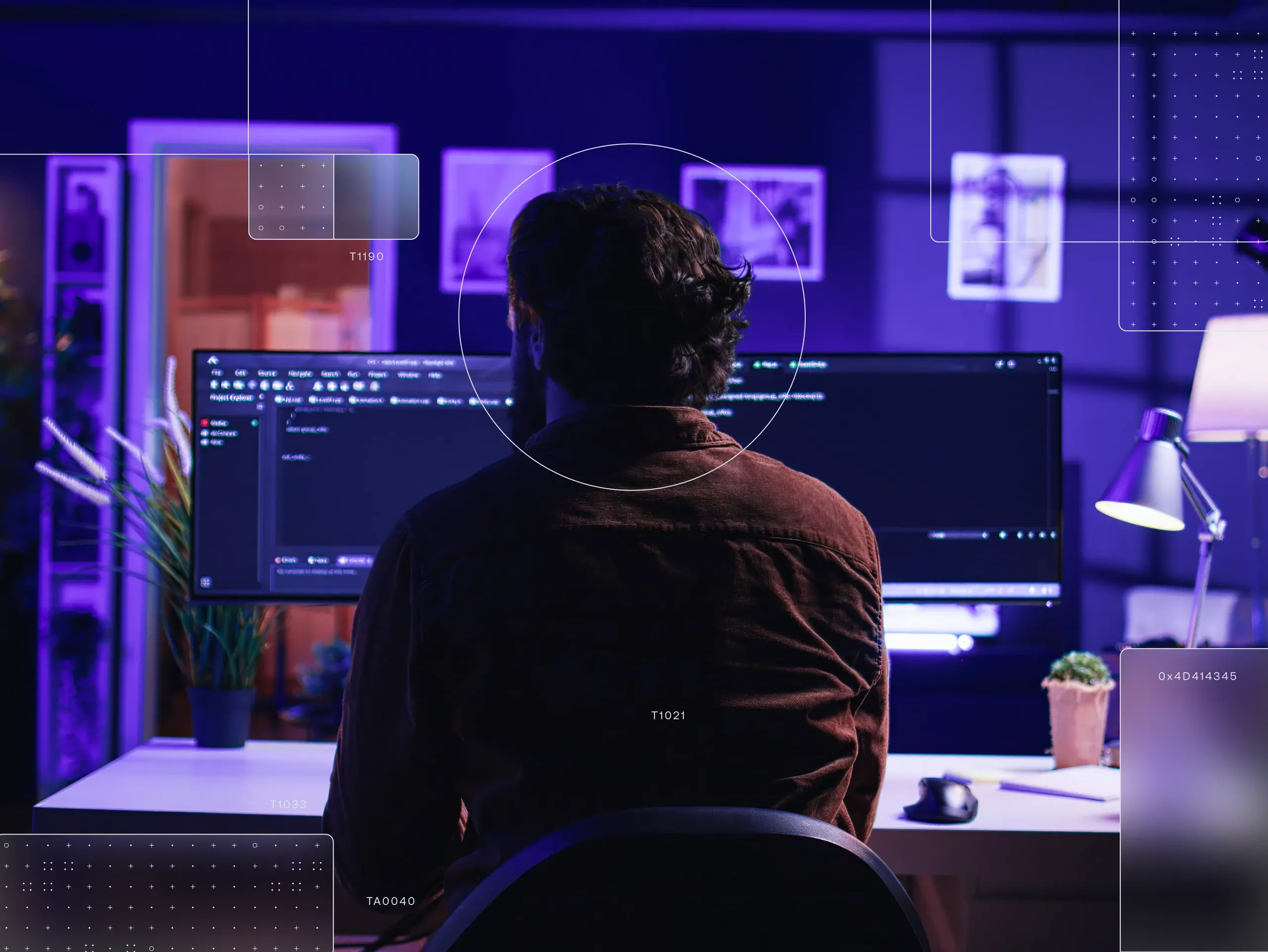 Person working at a desk with a dark software dashboard on a widescreen monitor, purple-blue lighting, HUD overlays