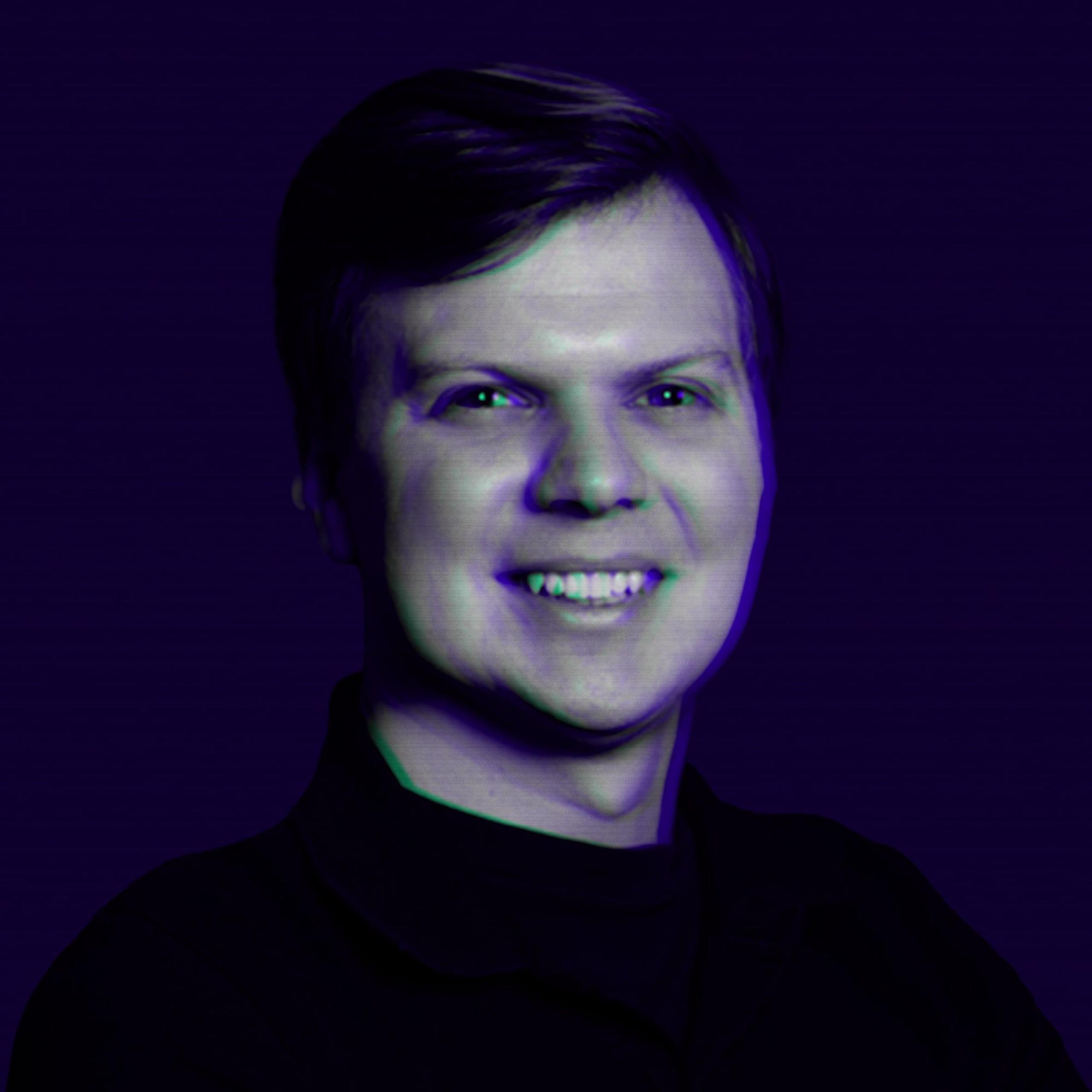 Smiling man chest-up portrait with purple-blue color cast and subtle glitch/chromatic fringe on face and hair