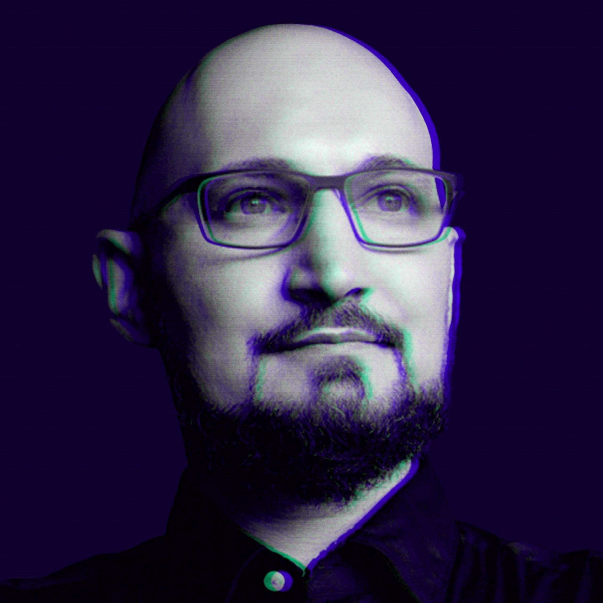 Stylized monochrome purple portrait of a bald man with glasses and short beard, poster-like close-up on dark purple background