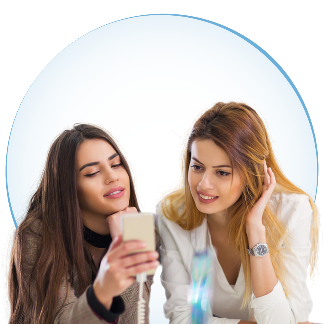 Two teen girls looking at a cell phone