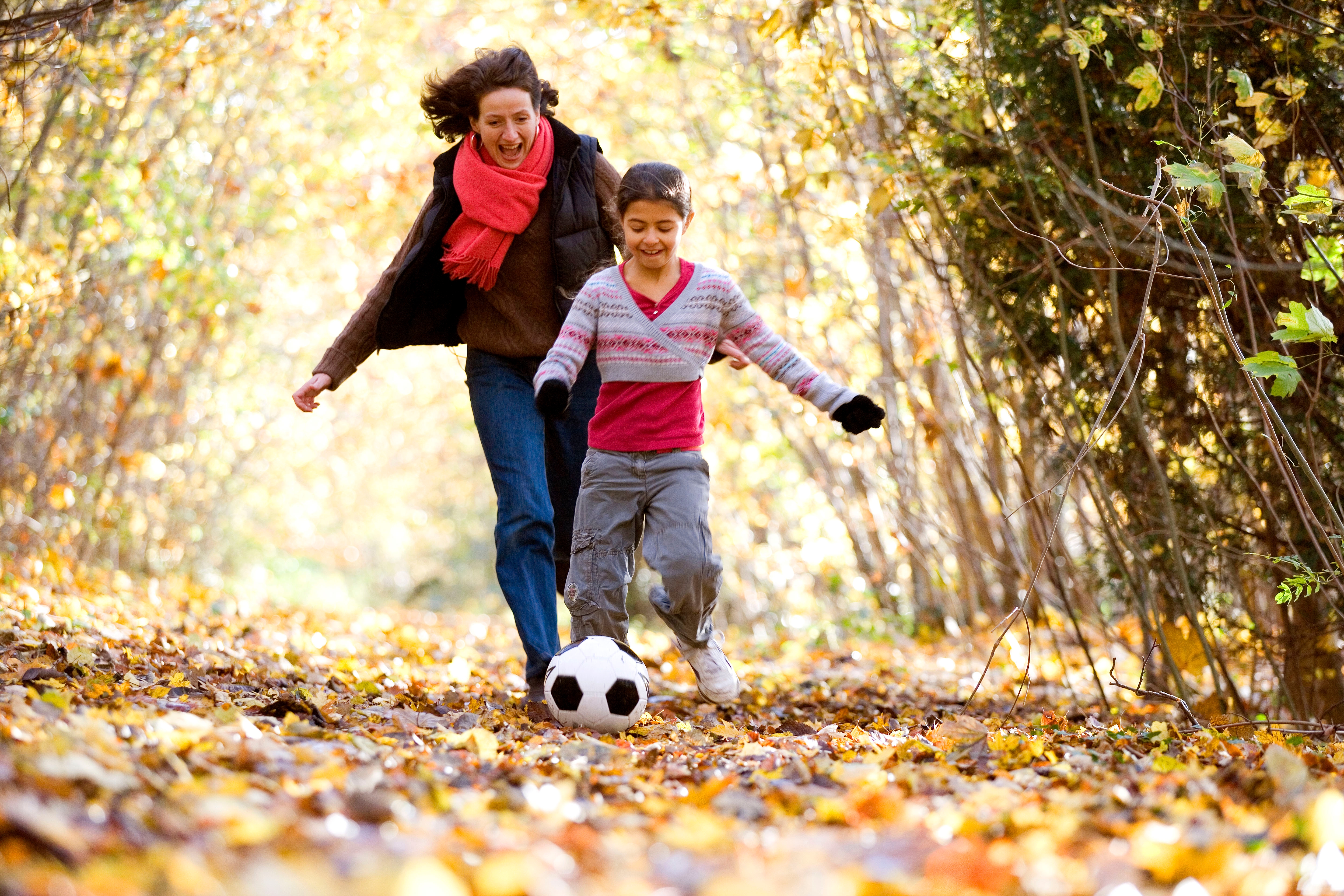 A mother and daughter playing at the park