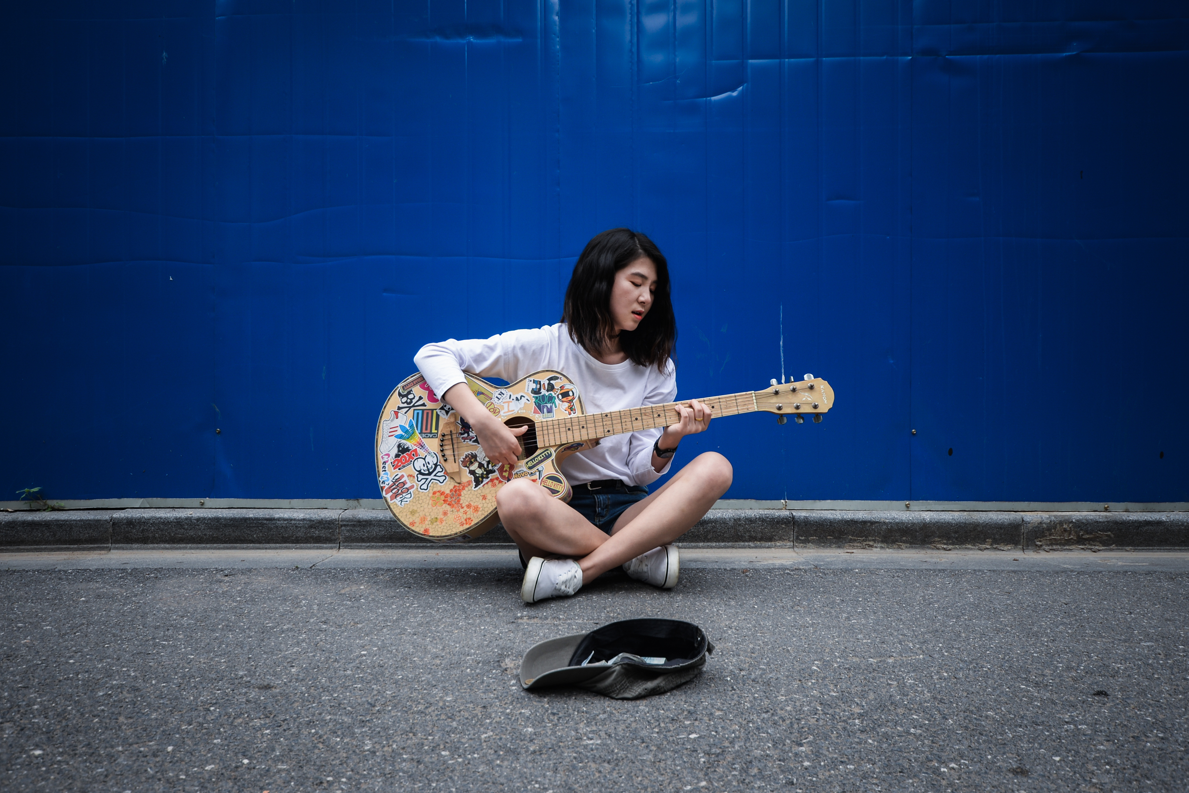 Young teen playing guitar at her free time.