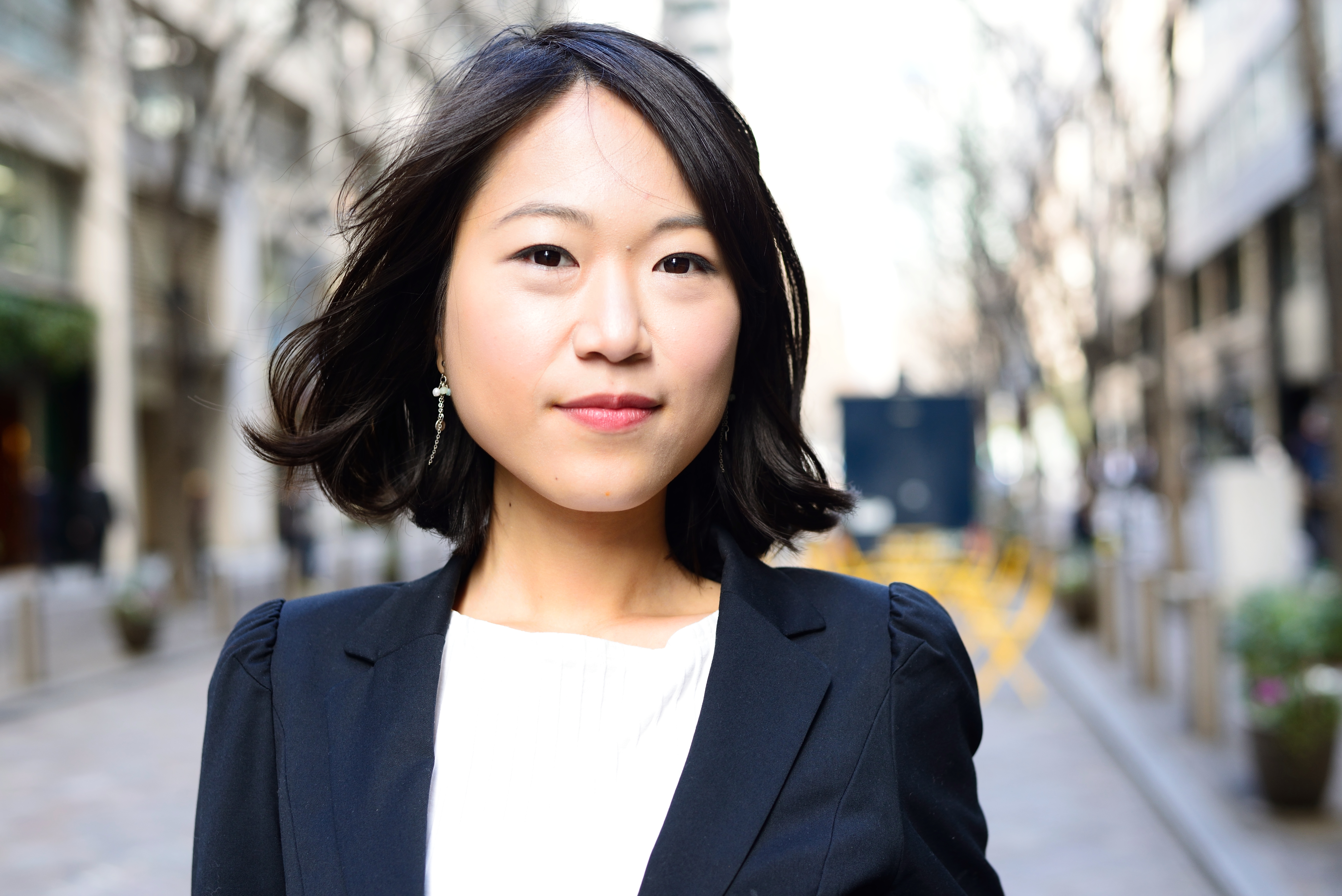 Asian woman with a confident look, wearing a business casual attire