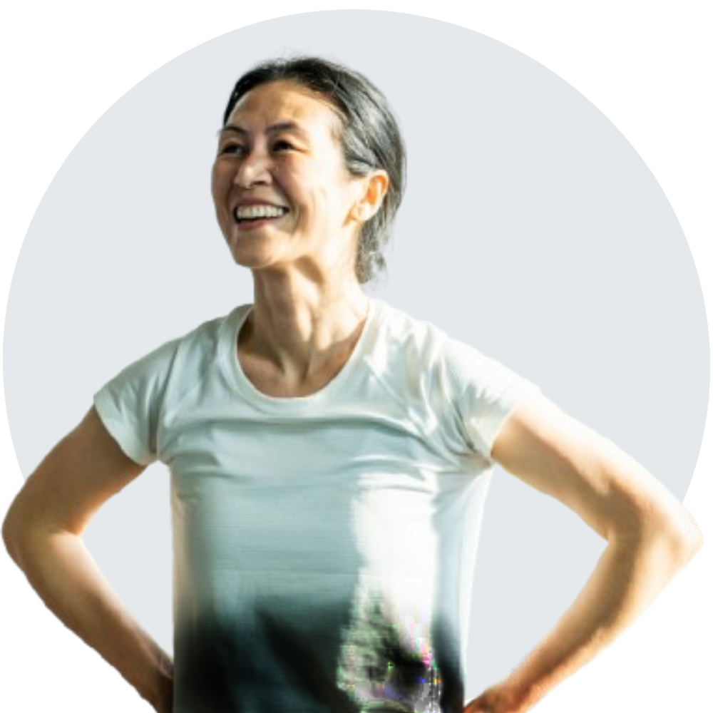 Woman with white shirt smiling while doing flying yoga