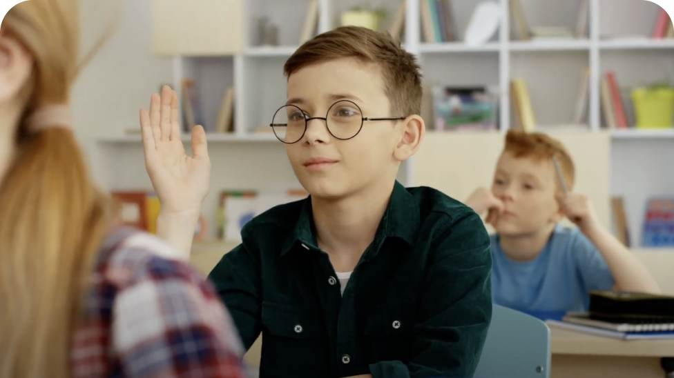 Child with glasses raising hand Child with glasses raising hand