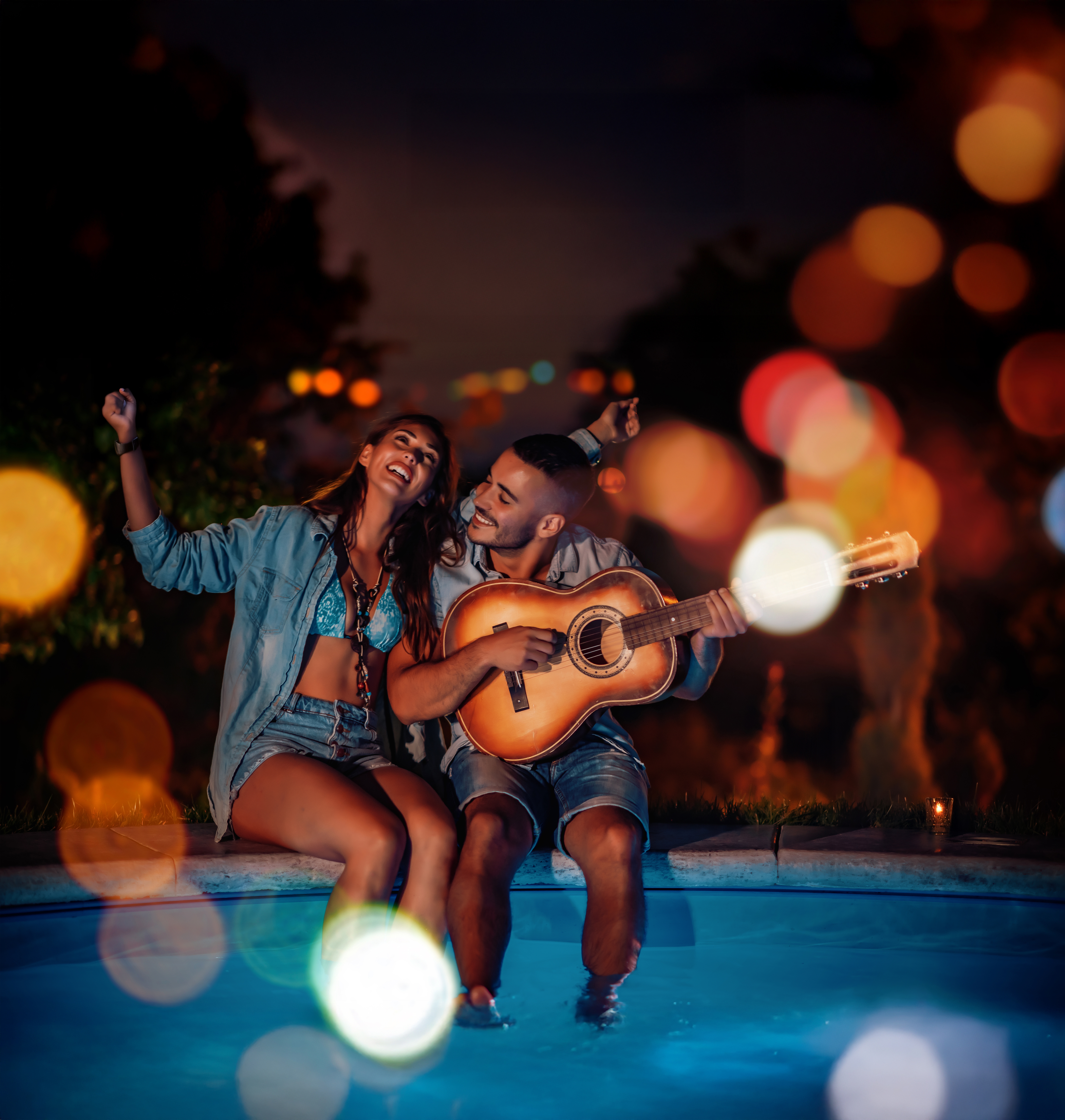 An image of a man playing guitar while a woman listens and dances An image of a man playing guitar while a woman listens and dances