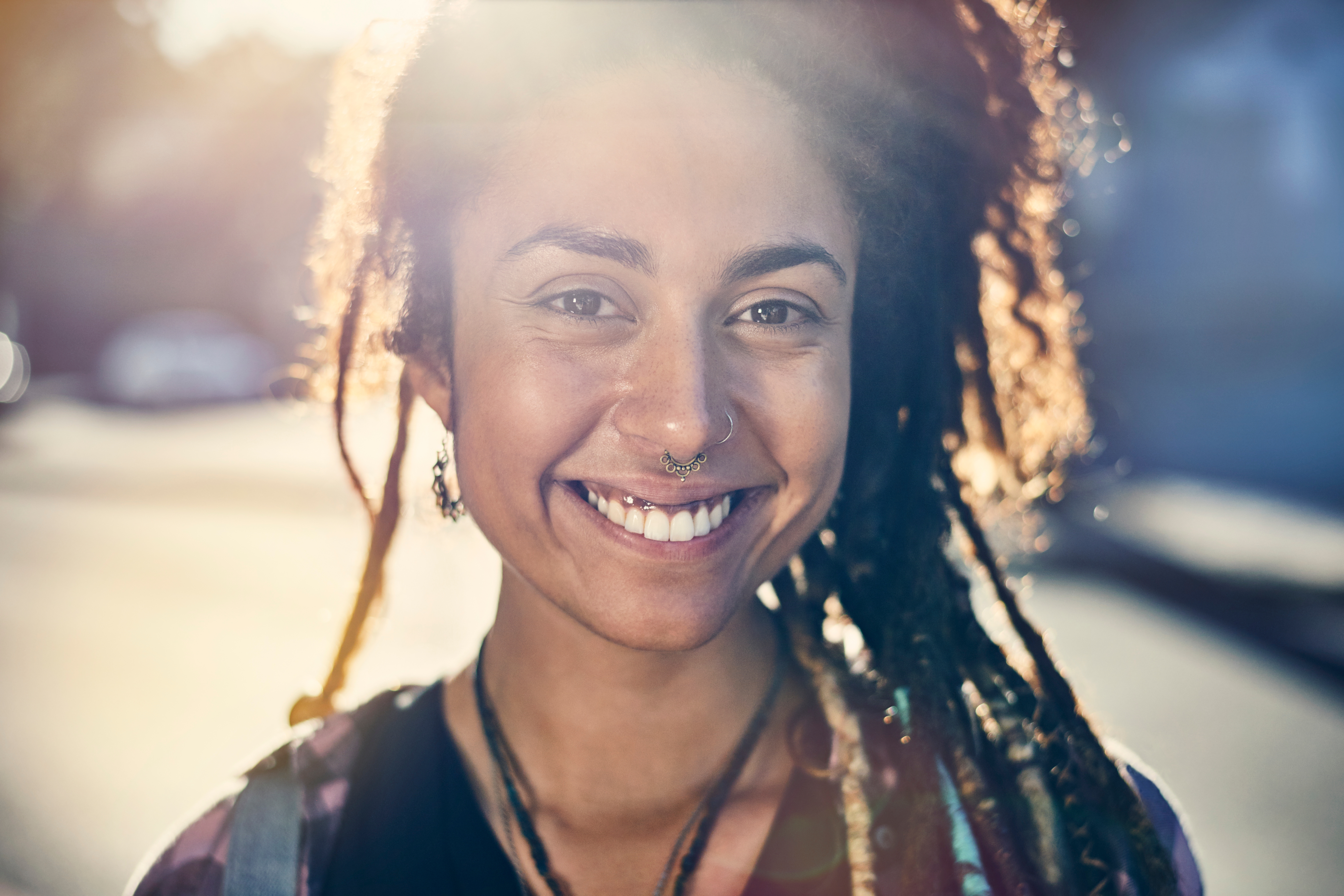 Smiling young teenager girl, with hair up smiling while looking at the front