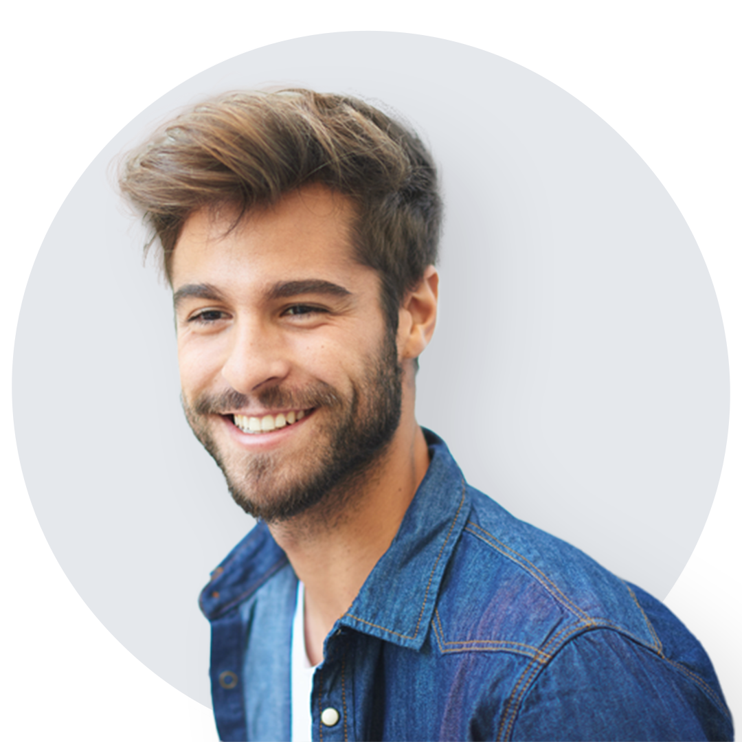 Smiling bearded young man in blue denim button down shirt