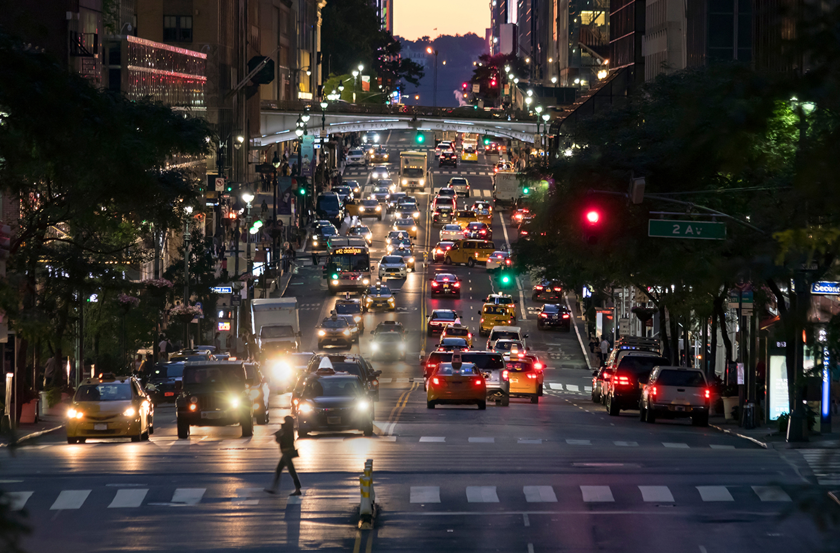 Image depicting crowded city street with cabs and cars