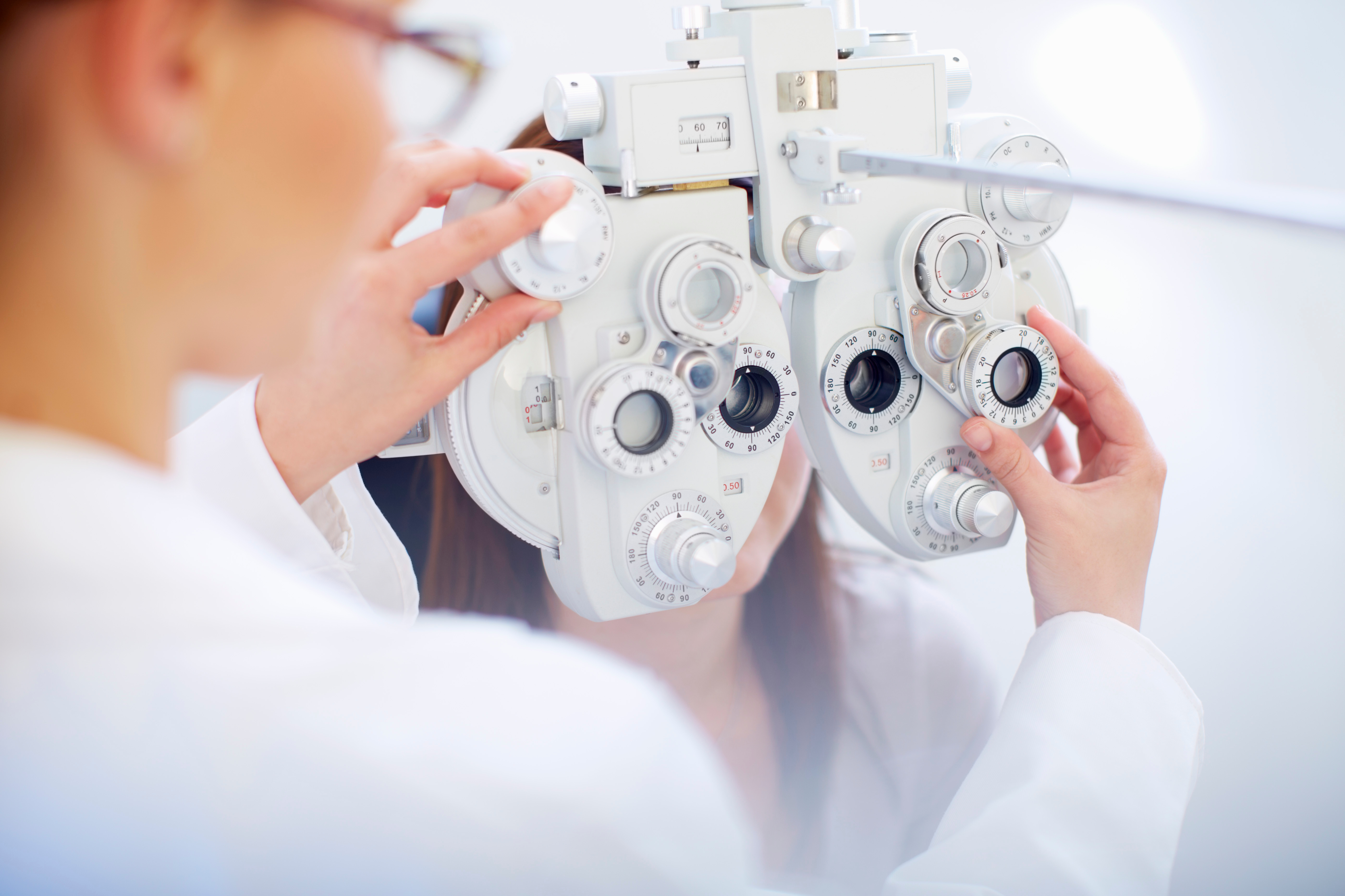 Ophthalmologist examining a young patient with an autorefractor.