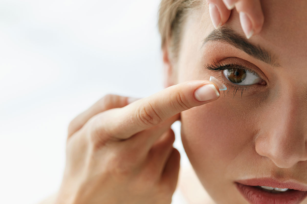 Young woman putting on Acuvue contact lenses