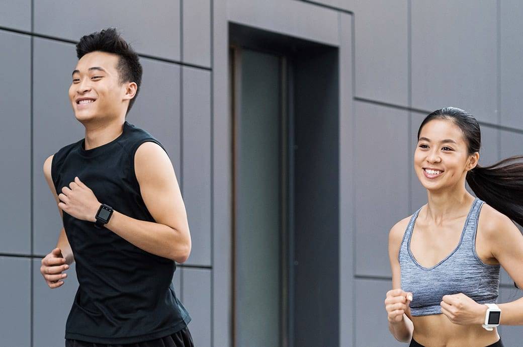  Active couple working out and running together quickly