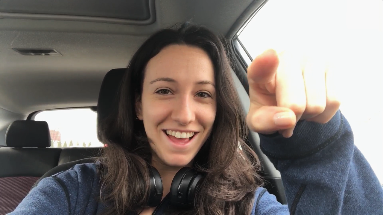 A young woman in the car who has the hang of contact lenses.