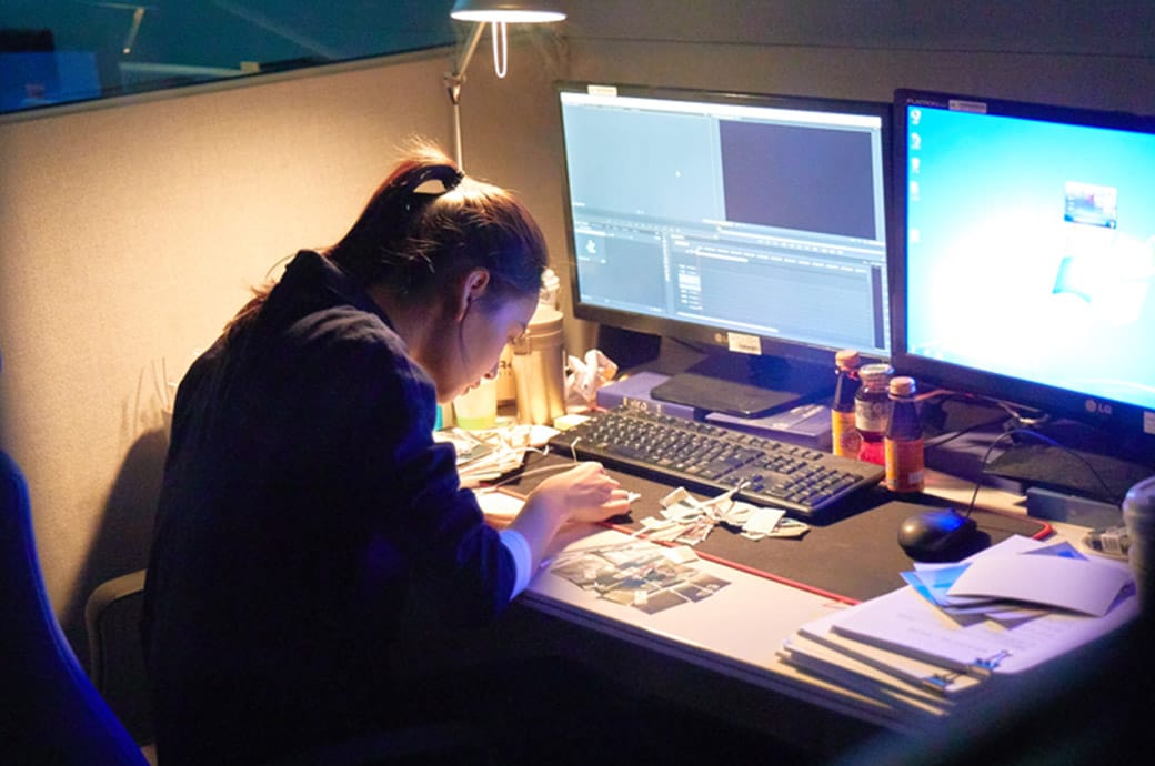 Woman concentrating and being hard at work at work desk