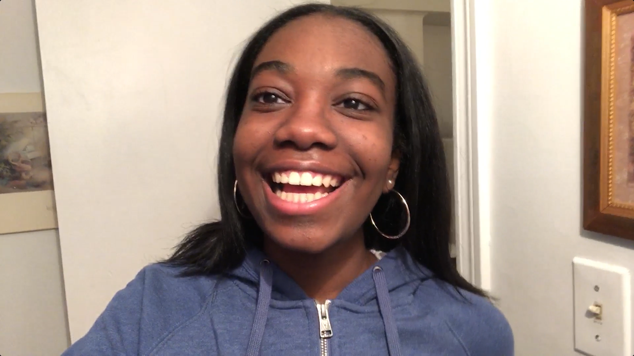 A confident, smiling young woman who has contact lenses.